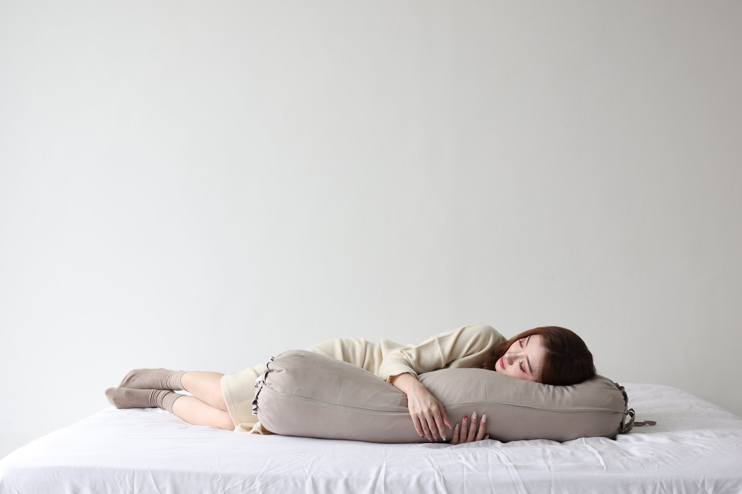 Woman resting with the Koalu Signature Bolster